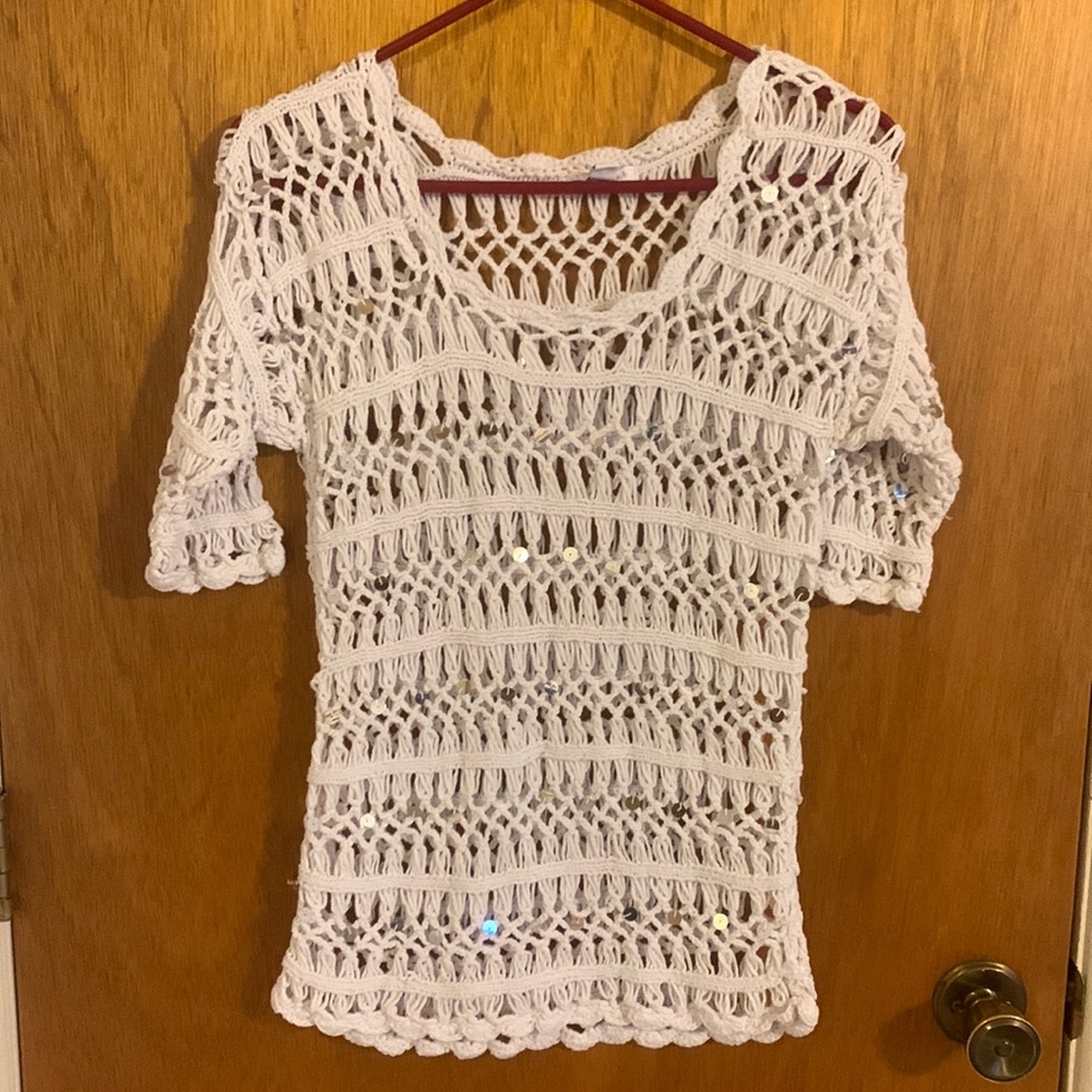Crocheted, cover-up top with large sequin design. Very cute.